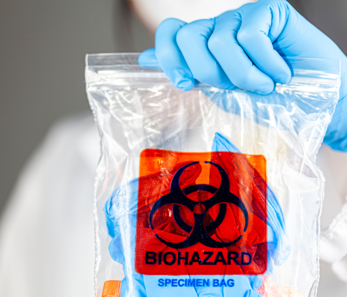 A professional showing a bag containing biohazard samples.